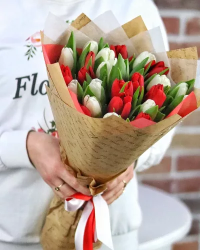 Букет из 25 красных и белых тюльпанов в крафтовой упаковке с белой калькой и атласной лентой