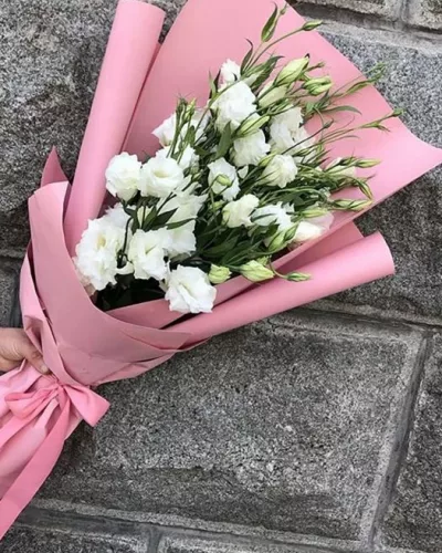 Монобукет из 7 белых эустом с зелёными бутонами в розовой матовой упаковке с атласной лентой